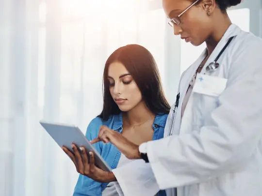 Clinician and patient reviewing a plan together on a tablet
